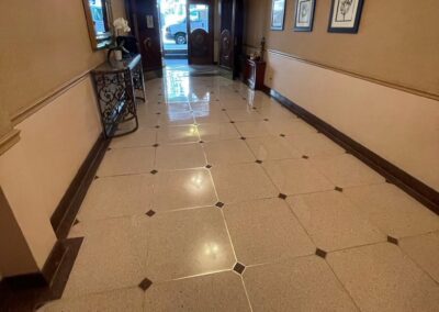 A hallway in a building with a tiled floor